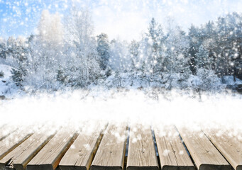 Winter landscape with snow and fir trees. Christmas, New Year background with wooden floor.