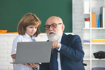 Online lessons. School teacher help to learn. Schoolboy learning in classroom. Education, teachering. Pupil kid lesson.