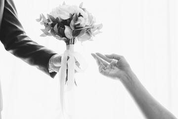 the bride holds her beautiful wedding bouquet with gentle hands