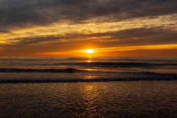 Fototapeta na wymiar A beautiful sunrise from the shore of the beach