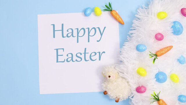 Happy Easter text write on paper with vibrant decoration on pastel blue background. Stop motion
