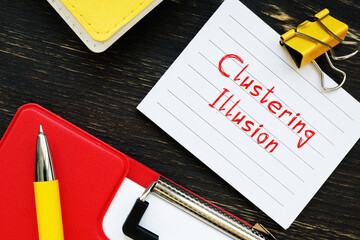 Business concept about Clustering Illusion with sign on the piece of paper.