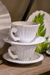 White porcelain teacup on a vintage wooden shelf