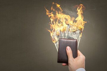 Burning Dollar banknotes inside a wallet