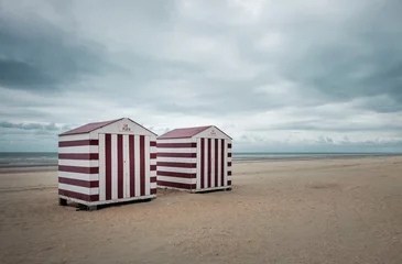 Fototapeten Two vintage beach cabins against grey sky © Erik_AJV