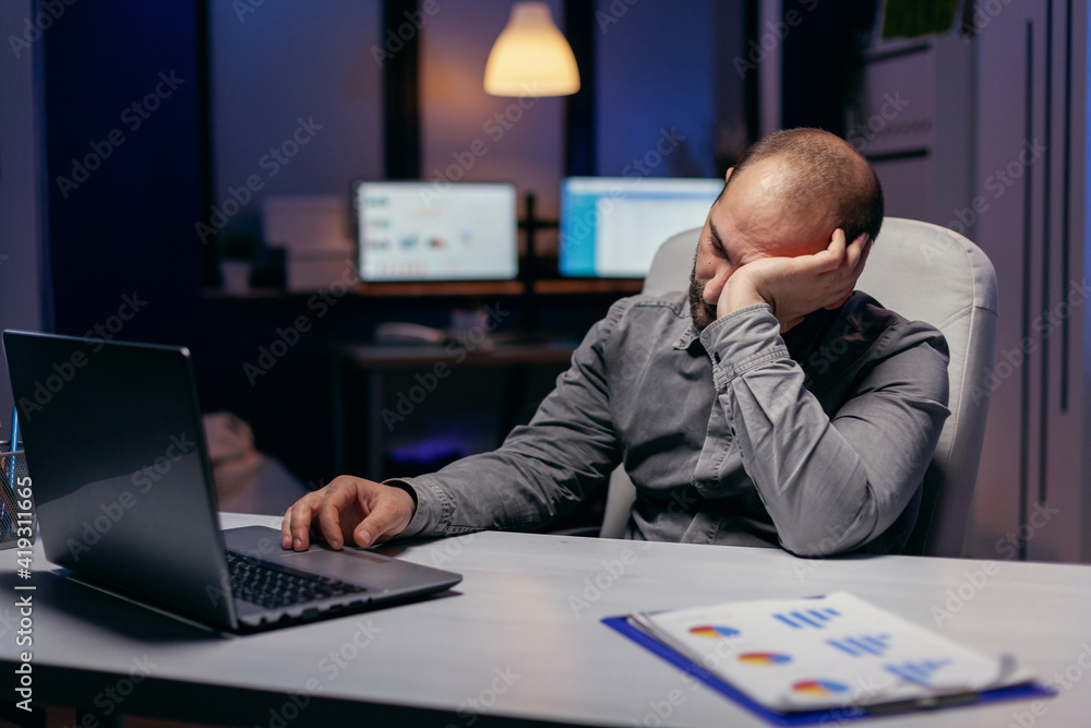 Poster hardworking manager napping at workplace with hand on laptop keyboard workaholic employee falling as