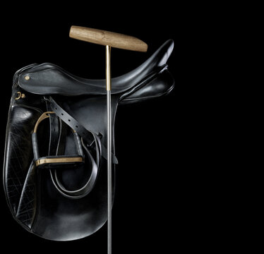 Polo game saddle with club on black background