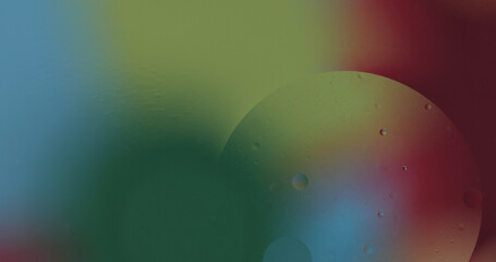 Oil bubbles on water abstract form in glass tank.