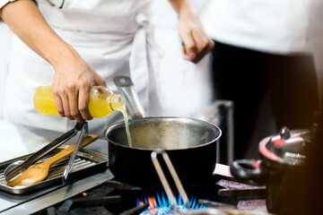 Obraz na płótnie Canvas Chef cooking, Chef preparing food in the kitchen