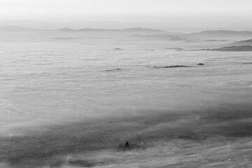 Surreal aerial view of Santa Maria degli Angeli church (Assisi, Italy) above a sea of fog