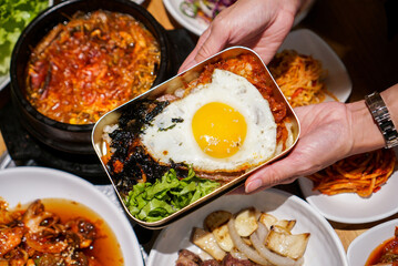 Korean rice box. A box of rice with kimchi, seaweed and fried egg. A traditional Korean food.