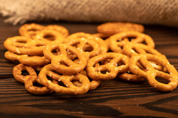 Salted breadsticks and salted pretzels scattered on the table.