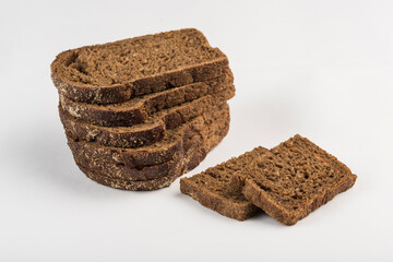 Black bread with tomatoes cut into pieces on a white background, isolated.