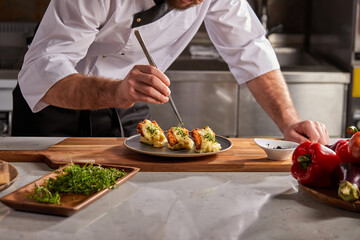 Cropped photo Close-up hands of male cook adding greens finishing dish, decorating meal in the end. gastronomy, food, nutrition, cafe concept
