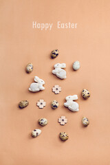 Fototapeta na wymiar Flat lay composition with naturally dyed easter eggs on a beige background. Natural sunlight lighting and soft shadows. Realistic aesthetic look. Organic natural easter concept