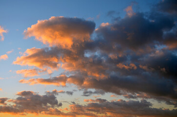 Sunset sky with clouds. Dramatic blue and orange, colorful clouds