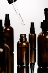 Face skin and body care concept, Healthy natural cosmetics in dark glass reusable bottles. Hyaluronic acid with pipette.