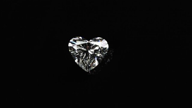 Heart shape diamond reflected on black background
