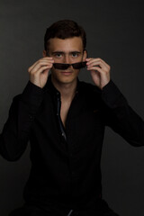 a young dark-haired man in a black shirt