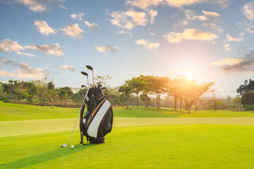 The Golf club bag for golfer training and play in game with golf course background , green tree sun...