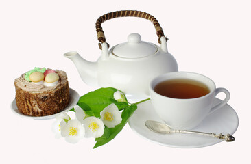 White faience cup of tea cake and jasmine flowers. Isolated on white background. 