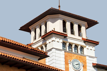 The tower is white with a clock in a tory style. Sunny summer day. Front view. © Николай Глухов