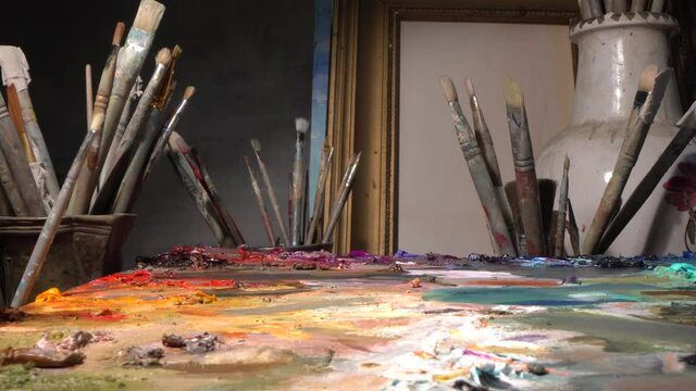 Creativity Workshop, art studio or Class for Artist. Professional painting tools, brushes, oil paints, palette, canvas, easel, picture frames, palette knife, antique tableware for still life