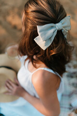 female hairstyle decorated with ribbon close-up back view