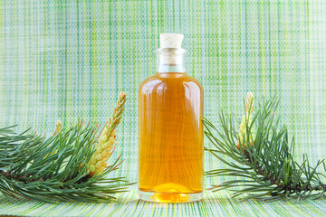 Essence of pine on table in beautiful glass jar