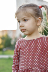 portrait of cute caucasian 4 year old girl in polka dot dress