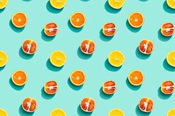 Colorful fruit pattern from fresh citrus, lemon, red orange on blue background. Summer food.