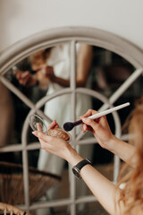 work of make-up artist close-up of girl's hands with cosmetics