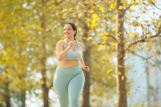 Fat woman jogging, doing sports for weight loss, obesity problem. High quality photo.