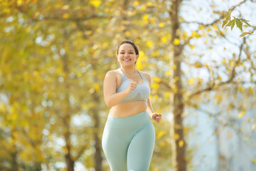 Fat woman jogging, doing sports for weight loss, obesity problem. High quality photo.