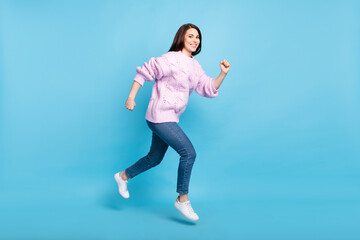 Fototapeta na wymiar Full body profile side photo of young woman happy positive smile go walk run hurry sale jump isolated over blue color background
