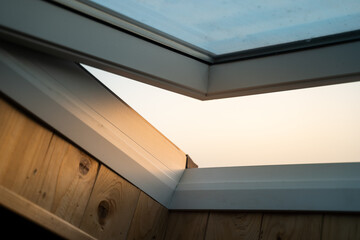 Obraz premium White wooden skylight, sunset light