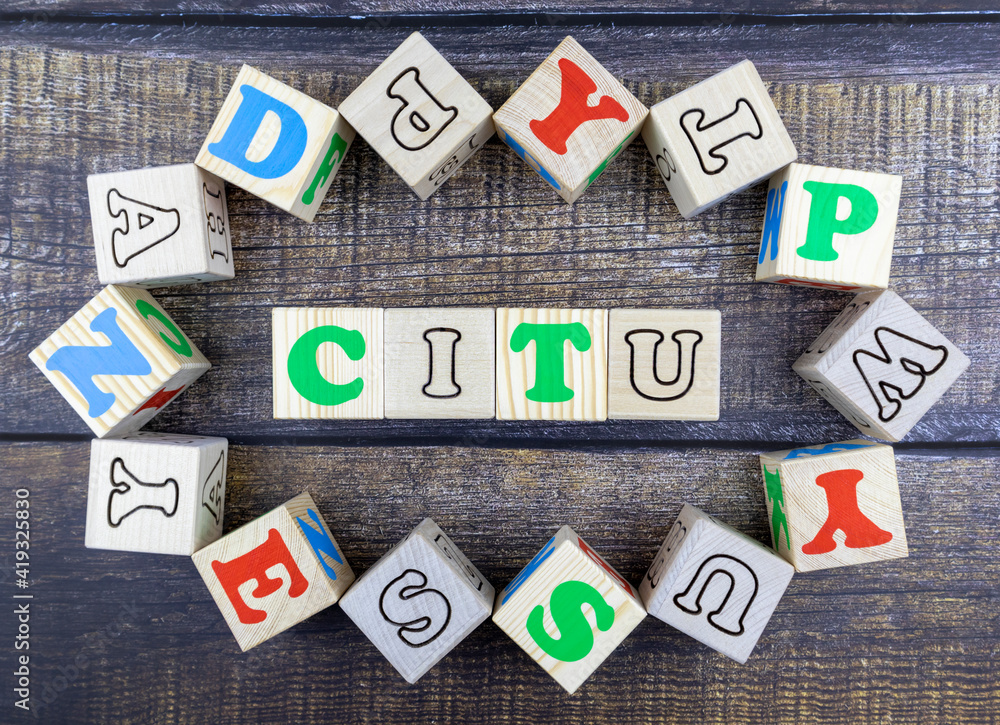 Poster word - city - in colorful alphabet letters on wooden cubes surrounded by a frame of additional rando