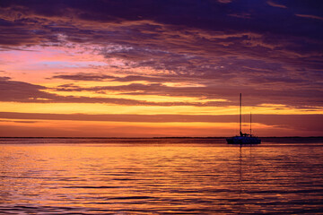 Naklejka na ściany i meble Yacht boat on the sea. Sailboats at sunset. Ocean yacht sailing.