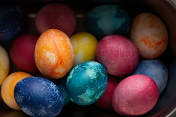 Easter eggs in a metal container close up on a black background