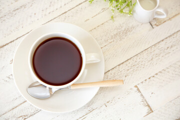 Coffee break time at your favorite cafe with a white wooden table.
