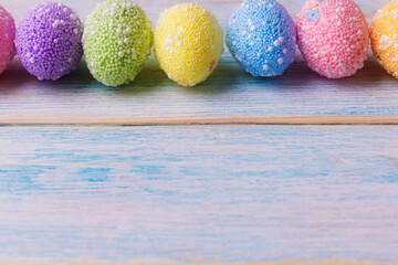 Decorated Easter eggs on wooden background with copy space