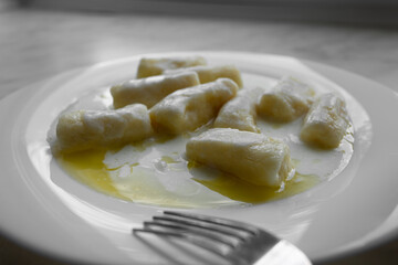 Closeup of dumplings with cottage cheese or Dumplings without filling - slavic light dish, vegetarian food, healthy breakfast