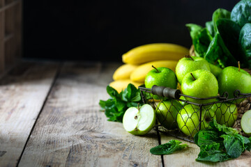 group of healthy green apples, spinach, bananas and mint are ingredients for a smoothie. Detox, diet, healthy, vegetarian food concept. Free space for text. Copy space.
