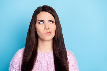 Photo of young woman serious think deep hmm creative ide plan look empty space isolated over blue...