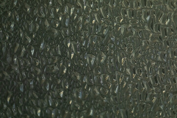 The background is made of dark green glass. The structure of cells and honeycombs.