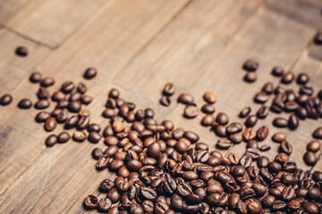Fototapeta na wymiar coffee beans scattered wood background morning aroma beverage preparation