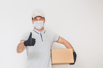 Courier in medical rubber gloves and protective mask holding cardboard boxes. Delivery service. Quarantine.