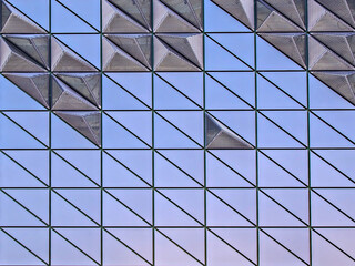 Facade of a modern building. Purple and lilac geometric shapes.