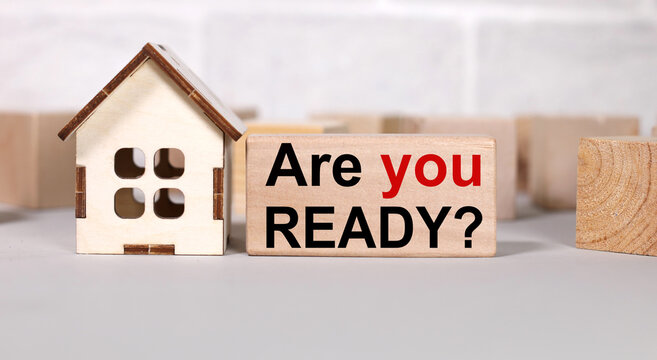 Are You Ready. Text In Black Letters On Wood Blocks. Near The House Figurine. Be Ready To Buy A House