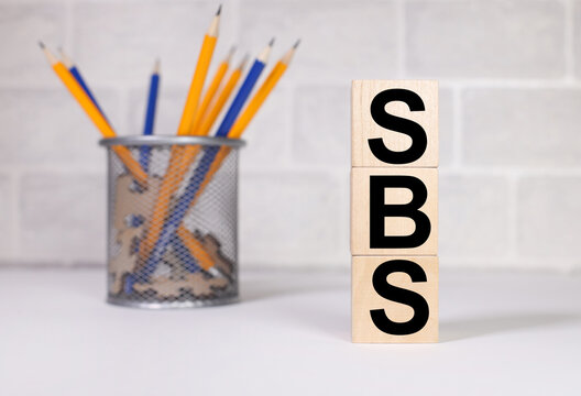 Special Broadcasting Service. SBS. text in black letters on wood blocks